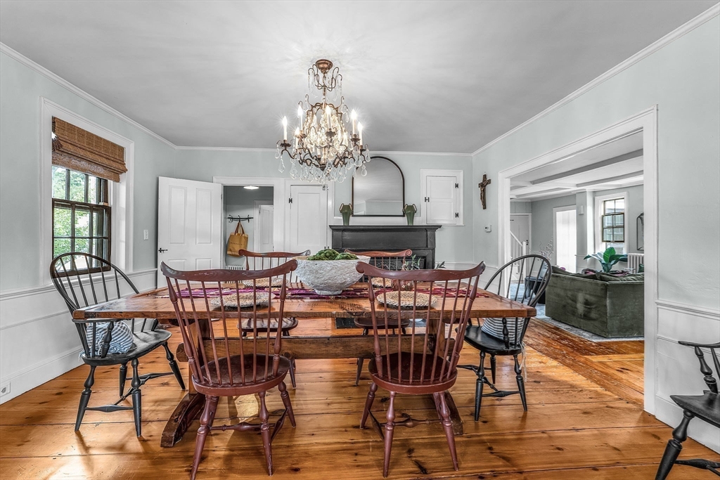 180 Elm Street Hanover, MA 02339 - Photo 13 of 30 a view of a dining room with furniture a chandelier and wooden floor