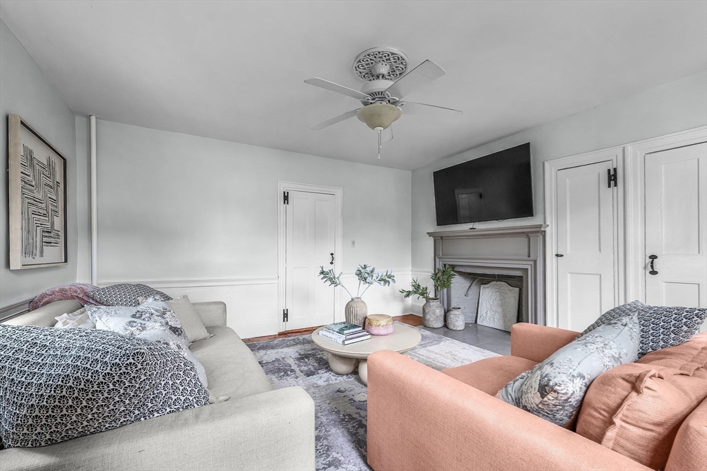 180 Elm Street Hanover, MA 02339 - Photo 15 of 30 a living room with furniture a fireplace and a flat screen tv