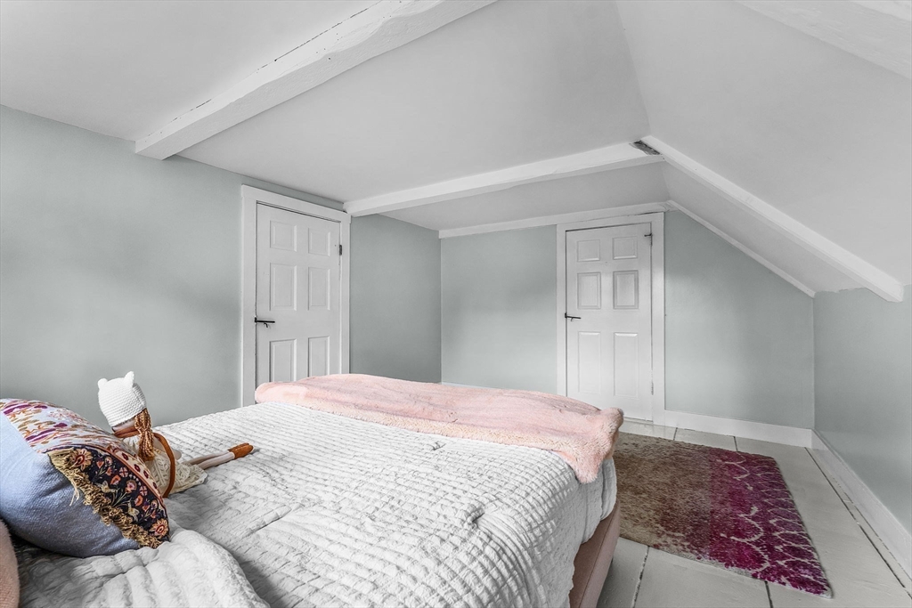 180 Elm Street Hanover, MA 02339 - Photo 17 of 30 a bedroom with a bed and a lamp