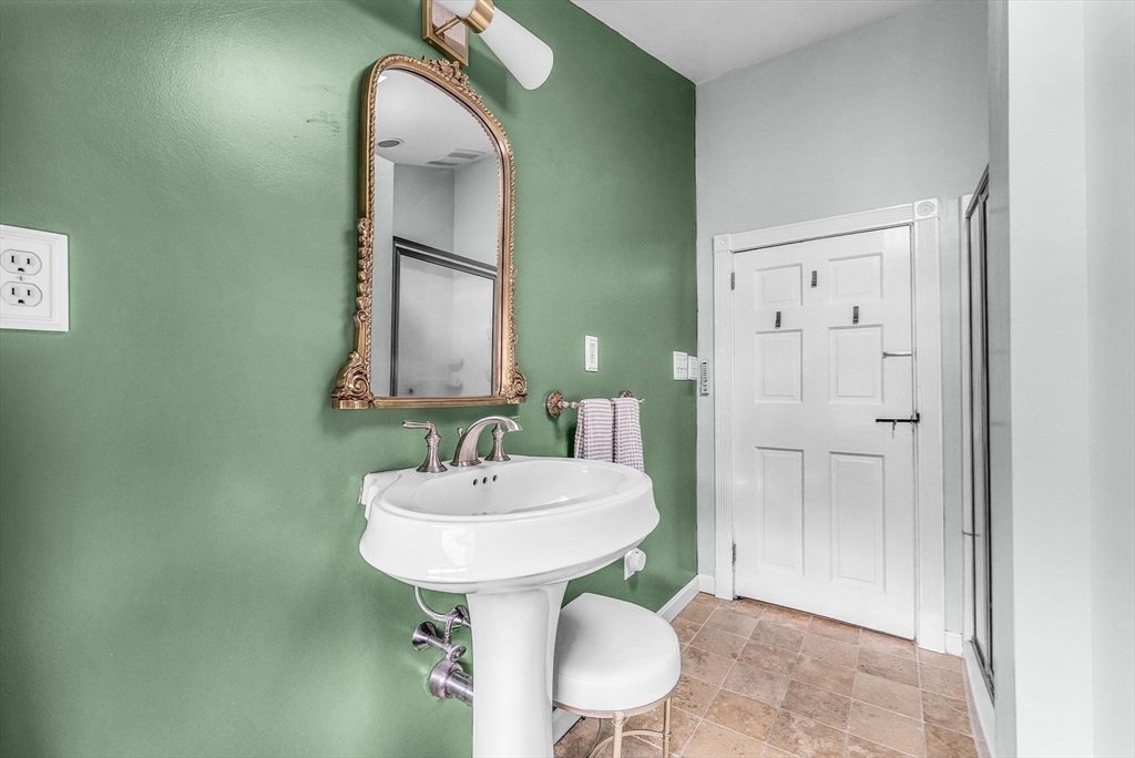 180 Elm Street Hanover, MA 02339 - Photo 19 of 30 a bathroom with a sink and a mirror