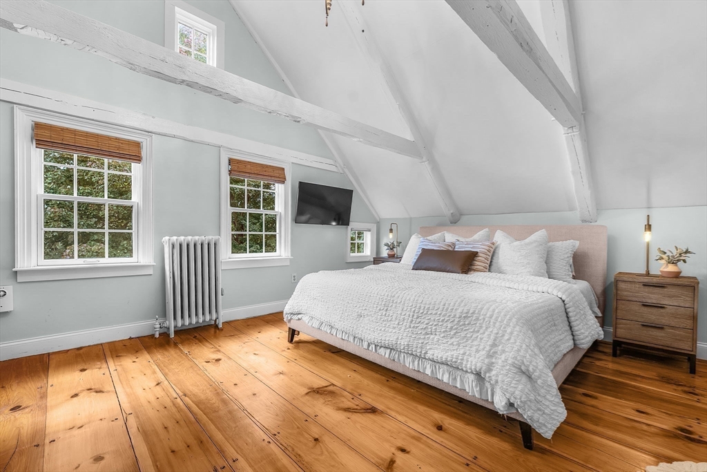 180 Elm Street Hanover, MA 02339 - Photo 22 of 30 a spacious bedroom with a bed and wooden floor