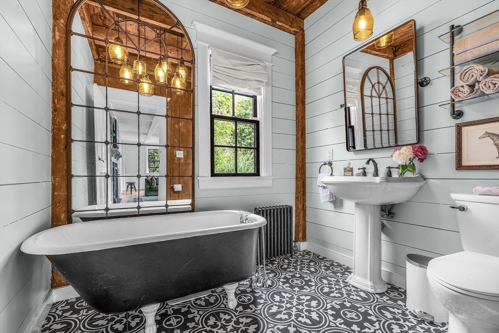 180 Elm Street Hanover, MA 02339 - Photo 4 of 30 a bathroom with a bathtub sink and toilet