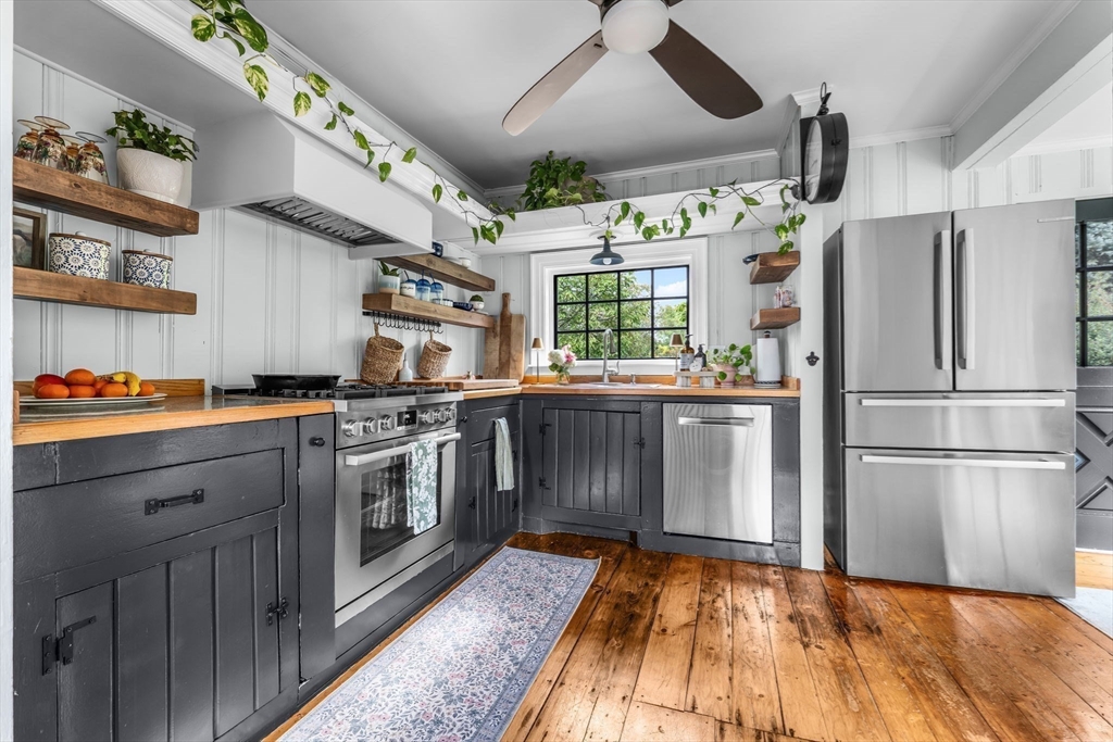 180 Elm Street Hanover, MA 02339 - Photo 7 of 30 a kitchen with stainless steel appliances granite countertop a stove and a refrigerator