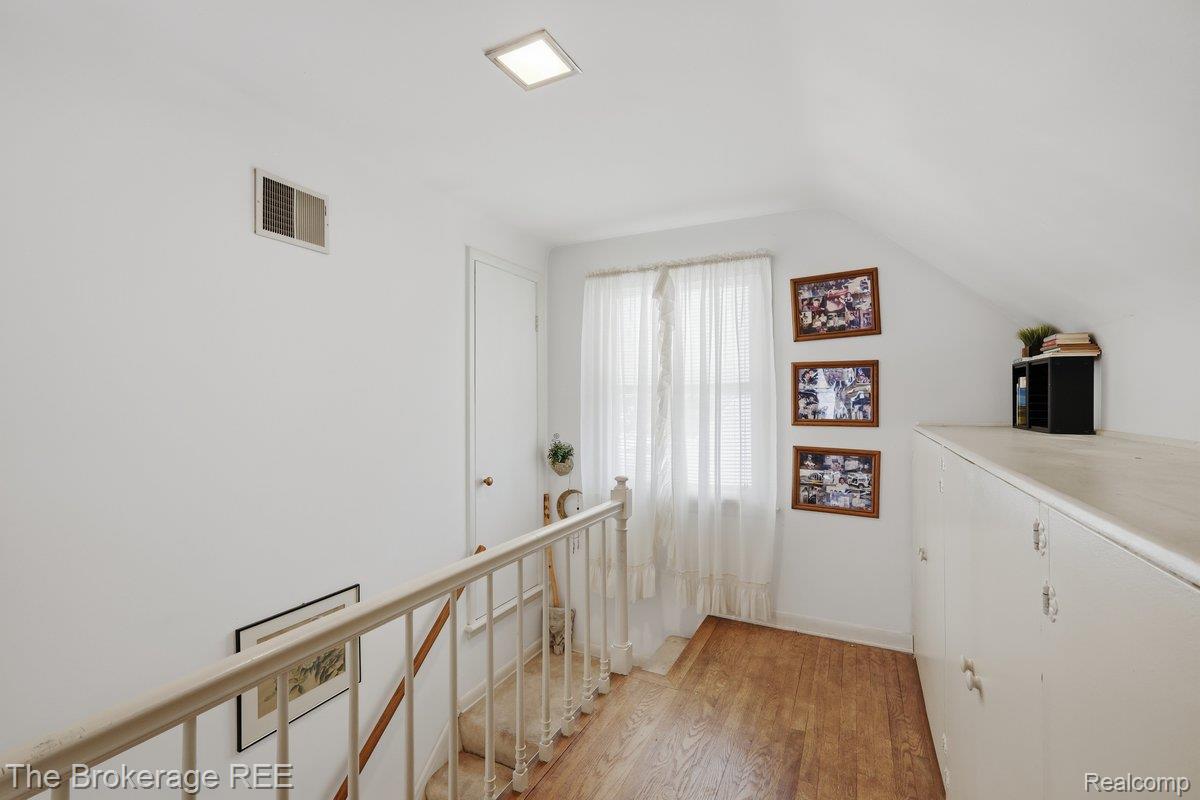 613 East Atherton Road Flint, MI 48507 - Photo 19 of 42 Hardwood-finish flooring, built-in storage cabinetry, attic access door, square recessed lighting, and a window with natural light