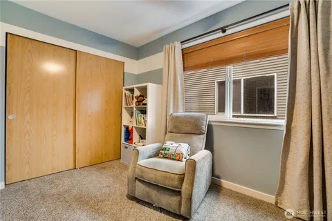 a bedroom with furniture and a window