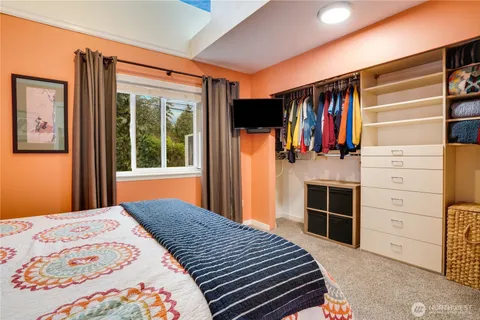a bedroom with a bed and a flat tv screen