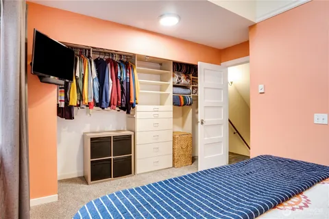 a view of walk in closet with clothes and shoes