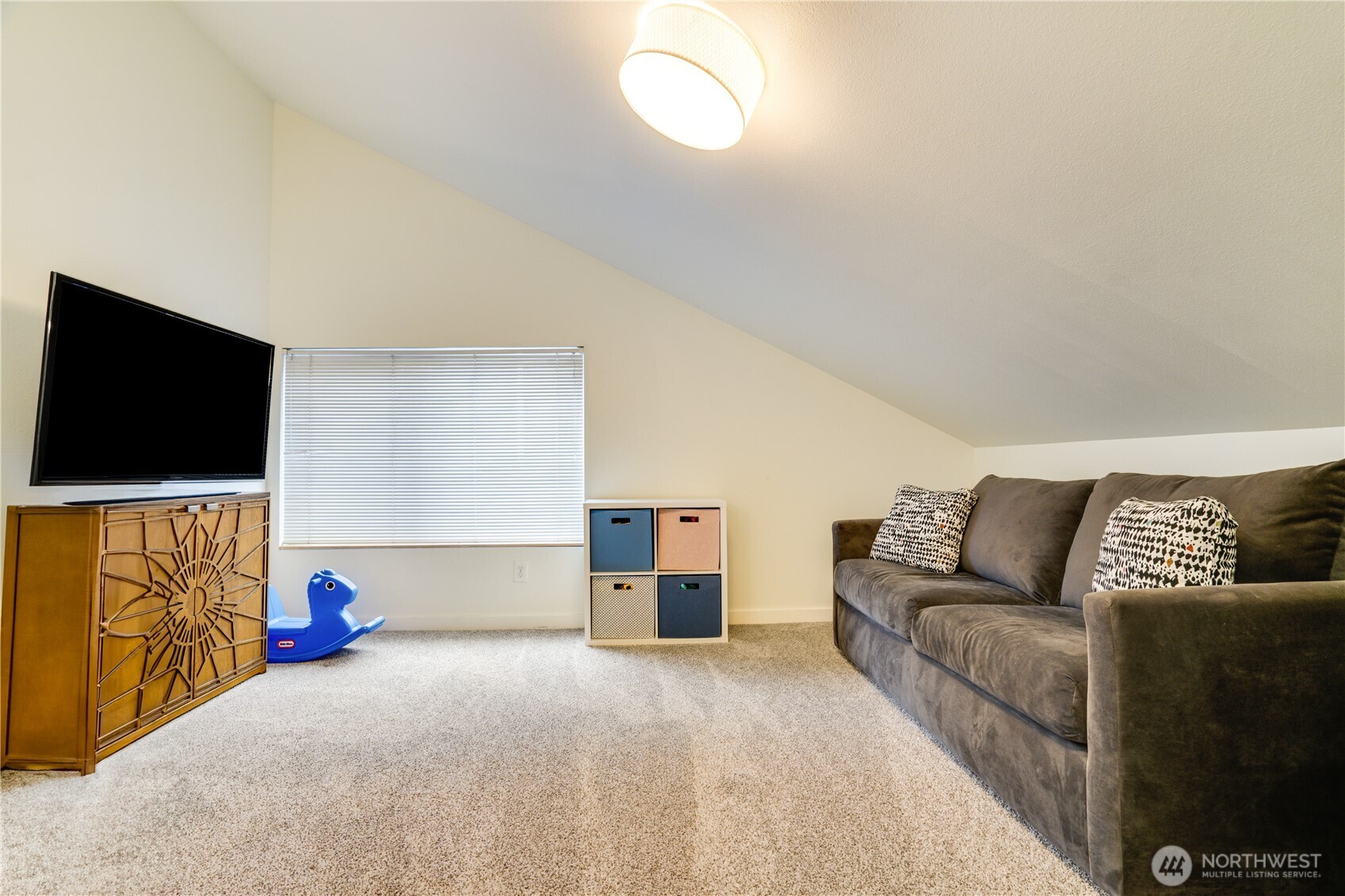 10319 Midvale Avenue North, Unit A Seattle, WA 98133 - Photo 24 of 34 a living room with furniture and a flat screen tv