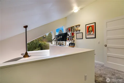 a view of a living room with furniture and floor to ceiling window