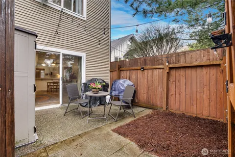a view of a patio with a table and chairs and potted plants