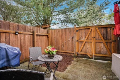 a backyard of a house with table and chairs