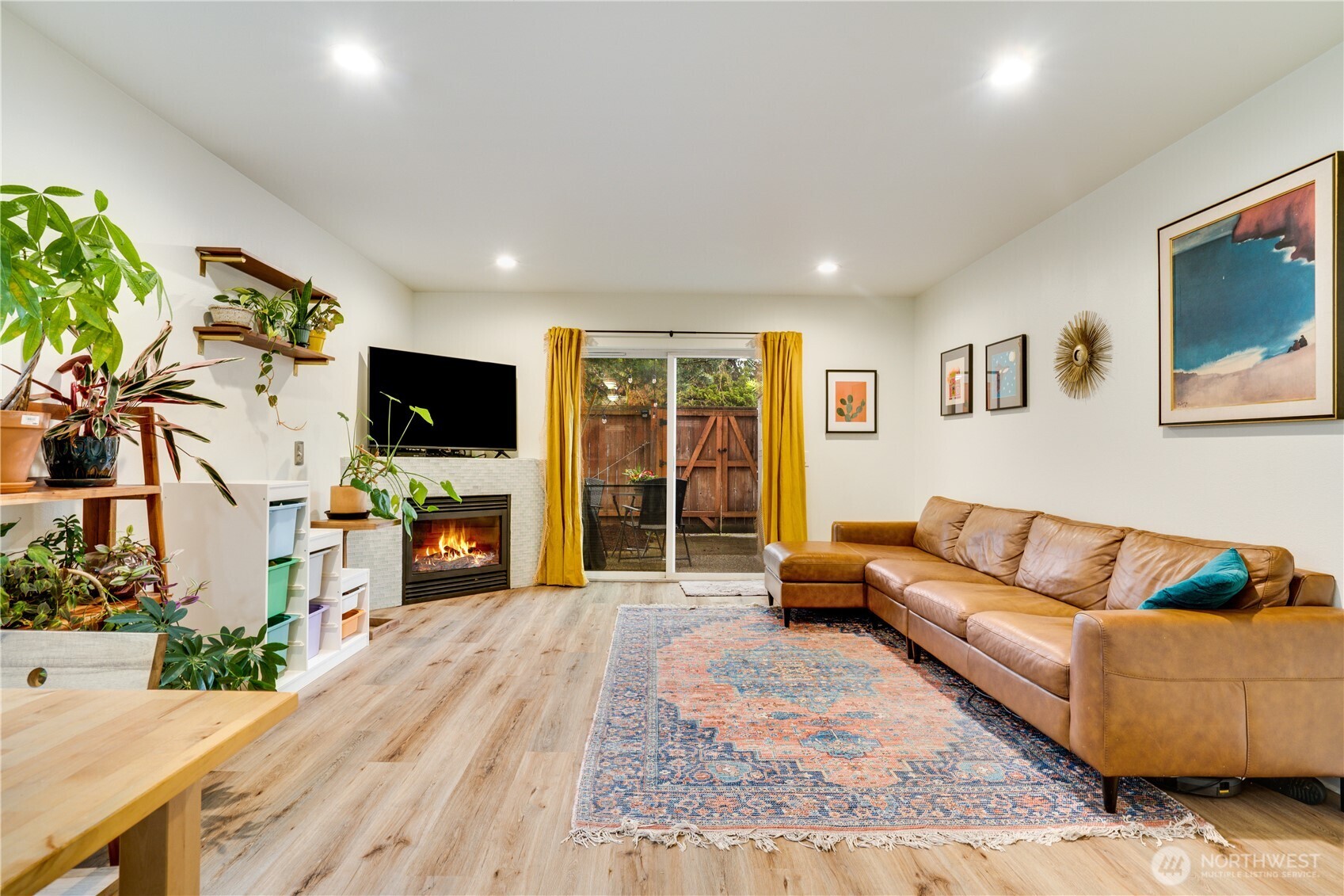 10319 Midvale Avenue North, Unit A Seattle, WA 98133 - Photo 4 of 34 a living room with furniture and a flat screen tv