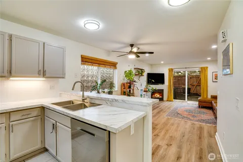 a large kitchen with kitchen island a sink stainless steel appliances and cabinets