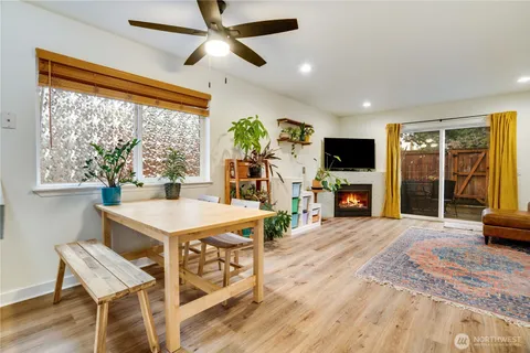 a view of a livingroom with furniture window and a kitchen
