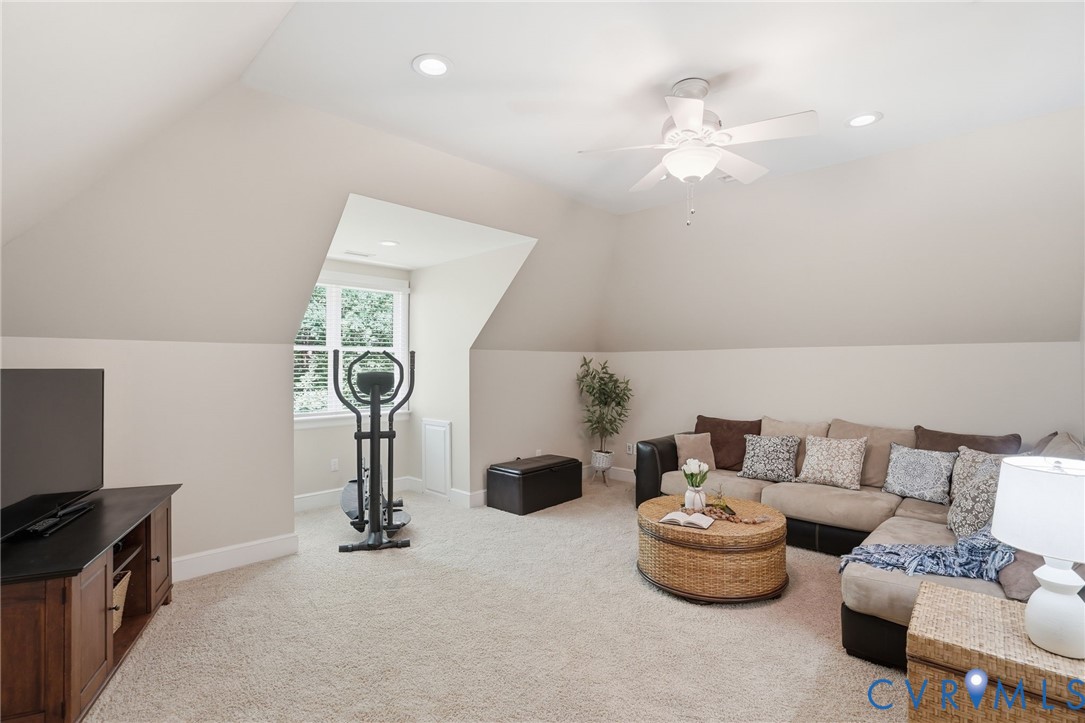 12123 Deer Ridge Court Ashland, VA 23005 - Photo 42 of 63 a living room with furniture a chandelier and a flat screen tv