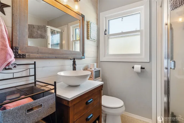a bathroom with a sink toilet and a mirror