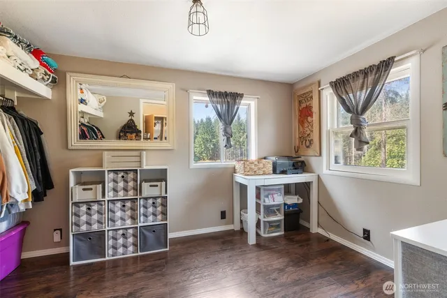 a view of a workspace with furniture and a window