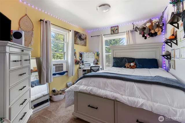 a bed sitting in a bedroom next to a window