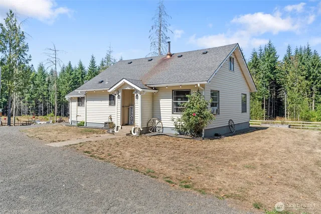 a view of a house with backyard and a tree