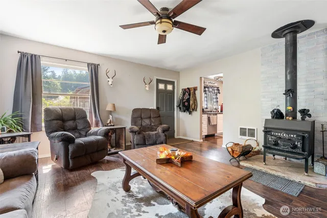 a living room with furniture a flat screen tv and a table