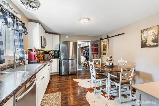 a kitchen with stainless steel appliances granite countertop a sink and a refrigerator
