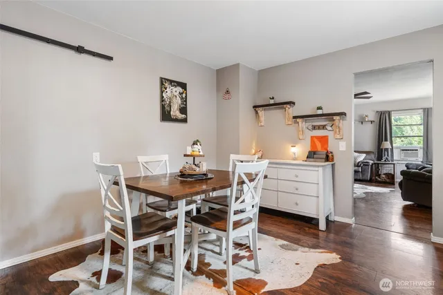 a dining room with furniture and wooden floor
