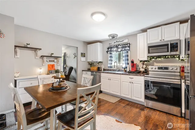 a kitchen with a dining table and chairs