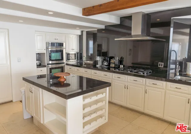 a kitchen with stainless steel appliances granite countertop a sink and a refrigerator