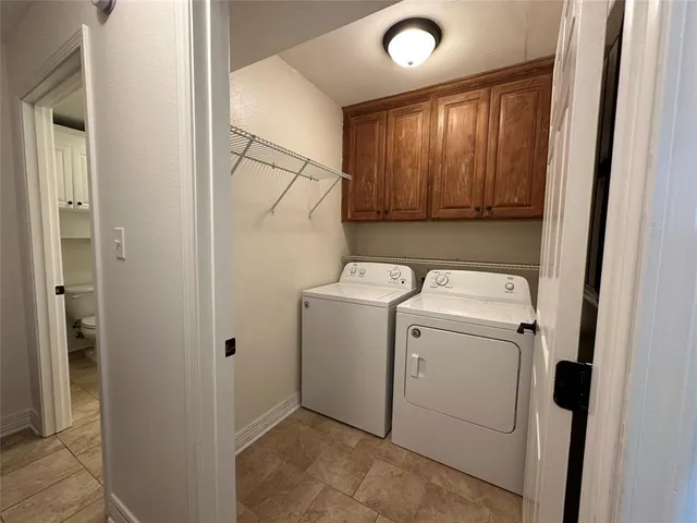 a view of storage and utility room with washer and dryer