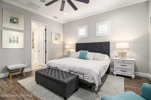 a bedroom with a bed and ceiling fan