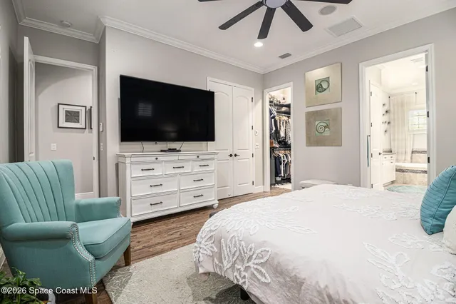 a bedroom with furniture and a flat screen tv