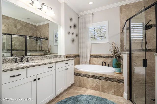 a bathroom with a granite countertop sink a toilet a mirror and shower