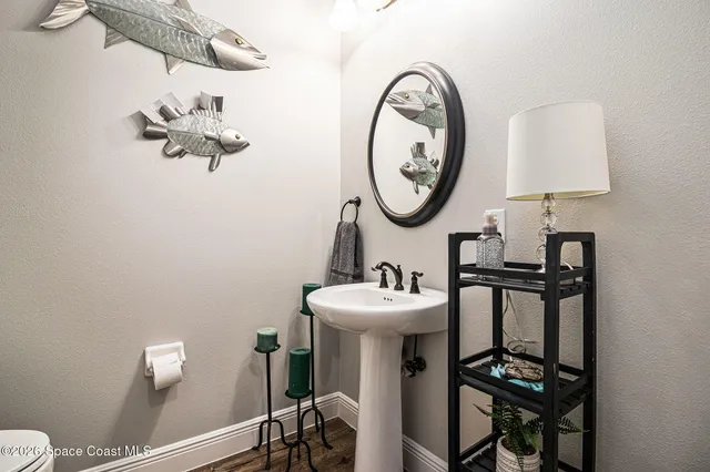 a bathroom with a sink mirror and toilet