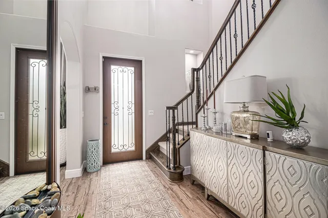 a view of entryway with wooden floor and stairs