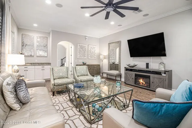 a living room with furniture a fireplace and a flat screen tv