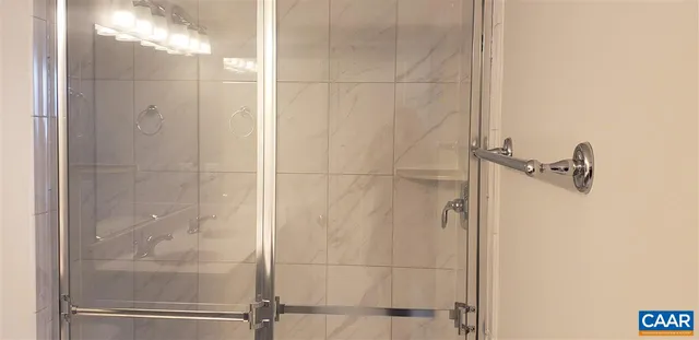 a bathroom with a glass shower door