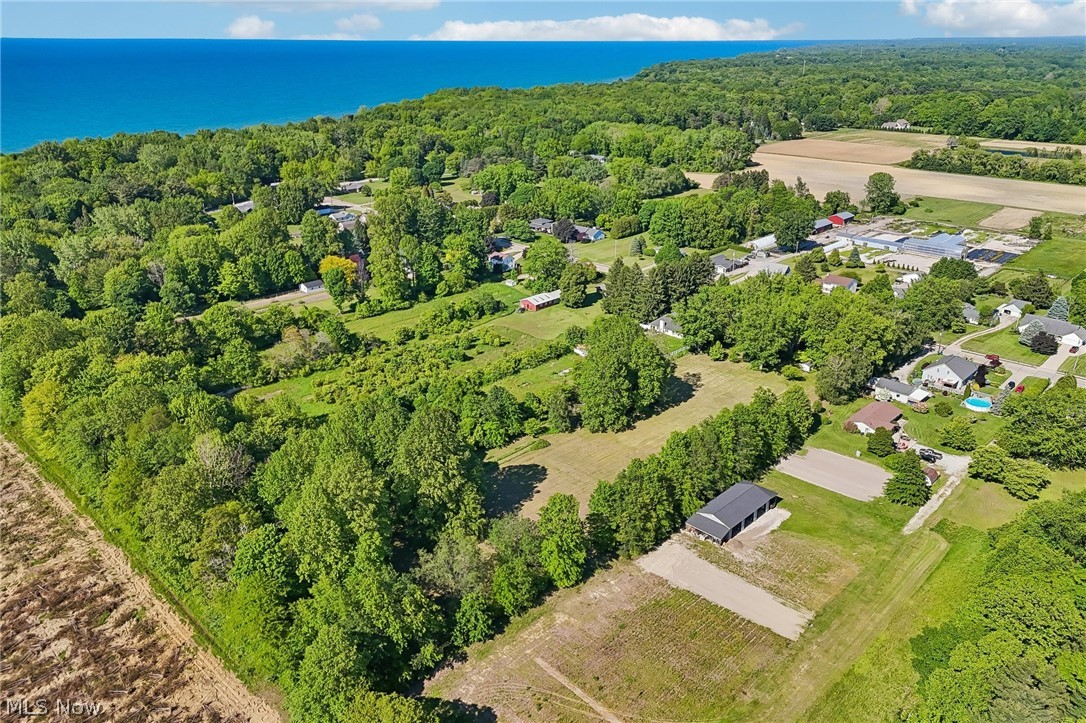 2428 Antioch Road Perry, OH 44081 - Photo 9 of 46 Expansive land parcel featuring wooded areas, cultivated fields, and open green spaces