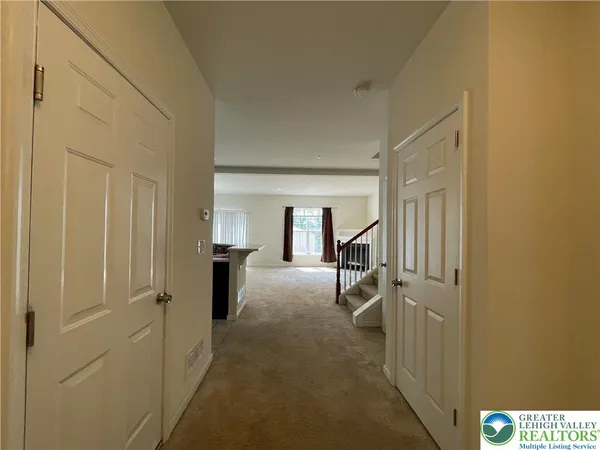 a view of a hallway with furniture and closet