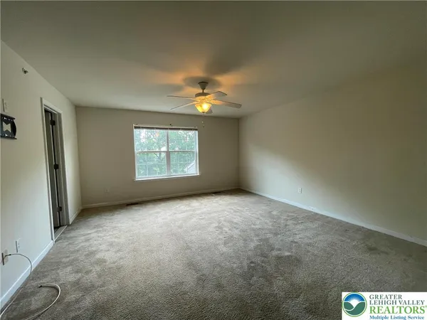 a spacious bathroom with a shower sink and mirror