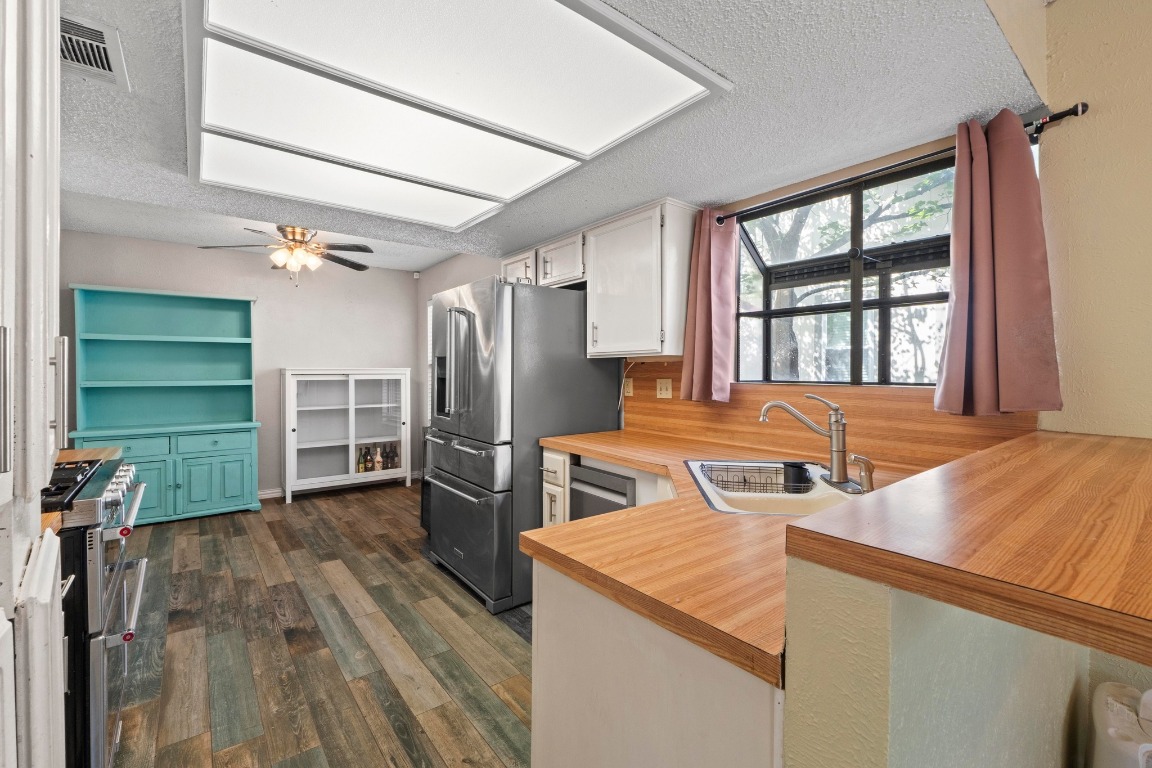 811 Timber Trail Cedar Park, TX 78613 - Photo 13 of 30 a kitchen with a refrigerator and a stove