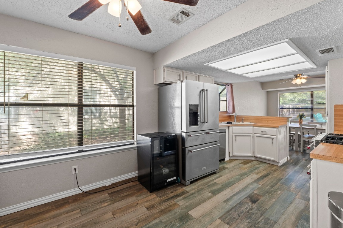 811 Timber Trail Cedar Park, TX 78613 - Photo 16 of 30 a large kitchen with a large window a counter space and stainless steel appliances