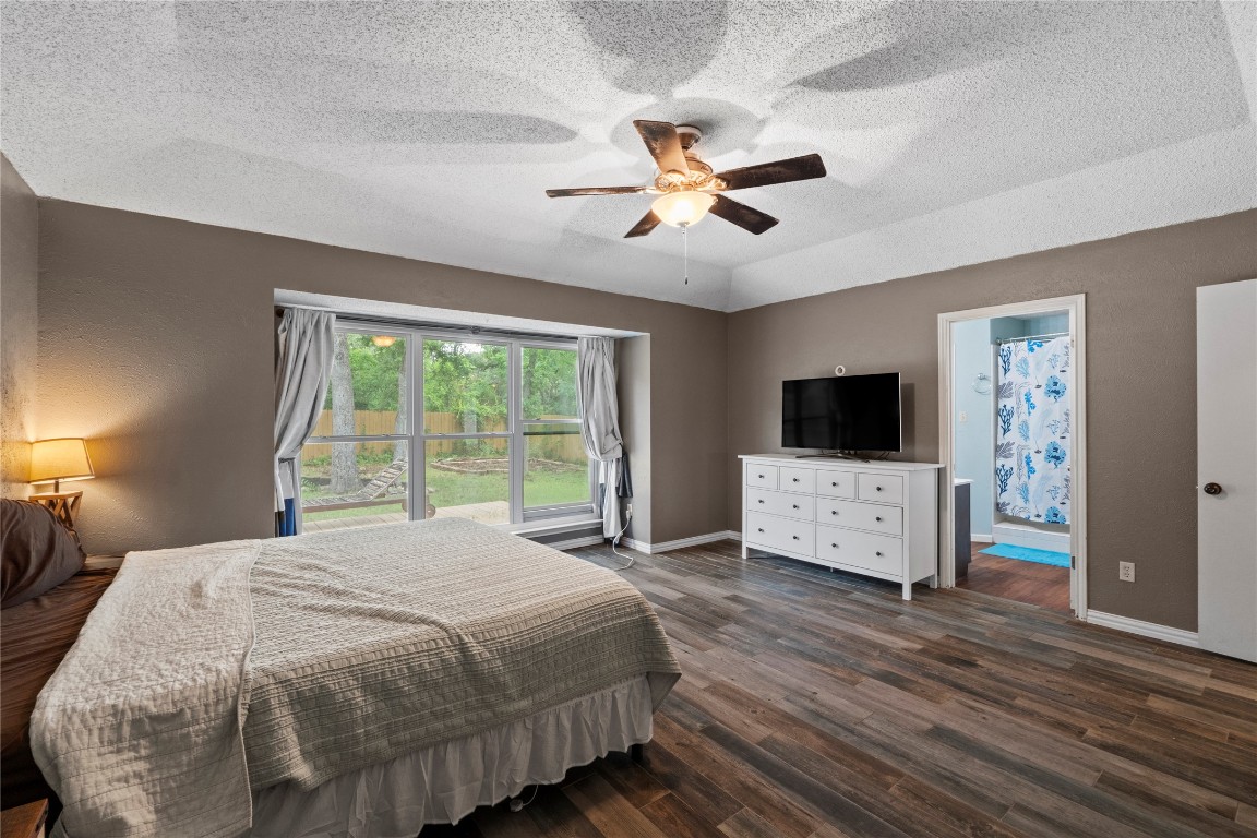 811 Timber Trail Cedar Park, TX 78613 - Photo 22 of 30 a bedroom with a bed and a flat screen tv