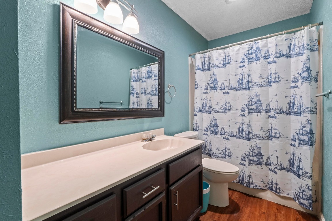 811 Timber Trail Cedar Park, TX 78613 - Photo 26 of 30 a bathroom with a sink a toilet and shower curtain