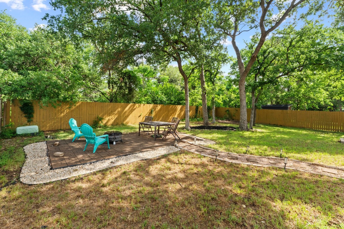 811 Timber Trail Cedar Park, TX 78613 - Photo 29 of 30 a view of backyard with table and chairs and a large tree