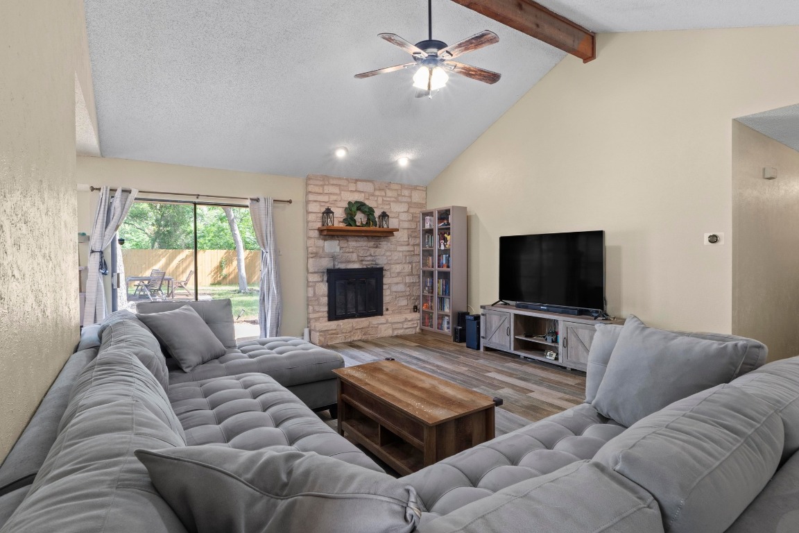 811 Timber Trail Cedar Park, TX 78613 - Photo 7 of 30 a living room with furniture a flat screen tv and a fireplace