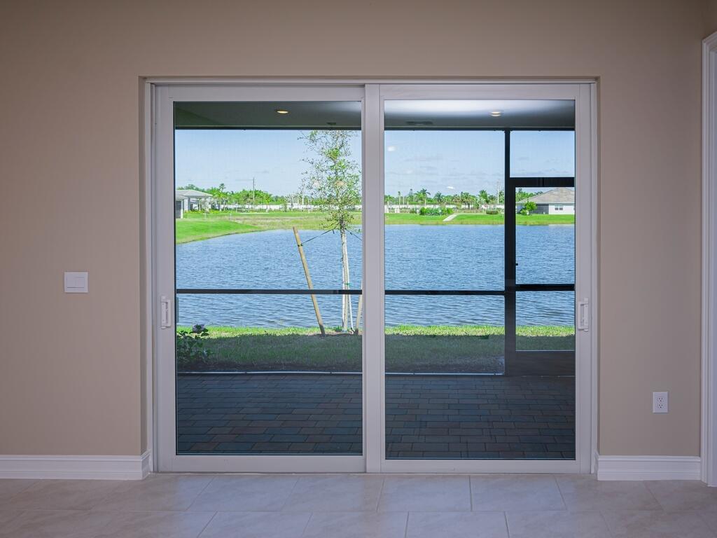 1087 Rolling Brk Lane Naples, FL 34114 - Photo 14 of 33 a glass door with a outdoor space