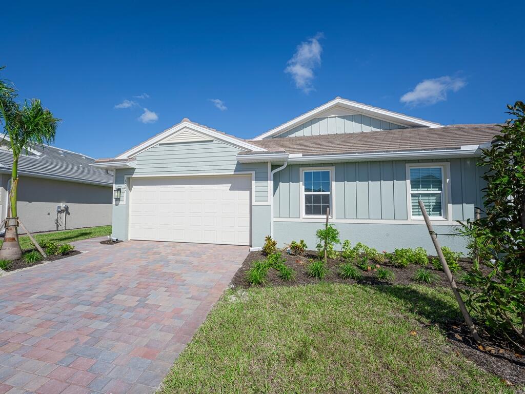 1087 Rolling Brk Lane Naples, FL 34114 - Photo 17 of 33 a front view of a house with garden