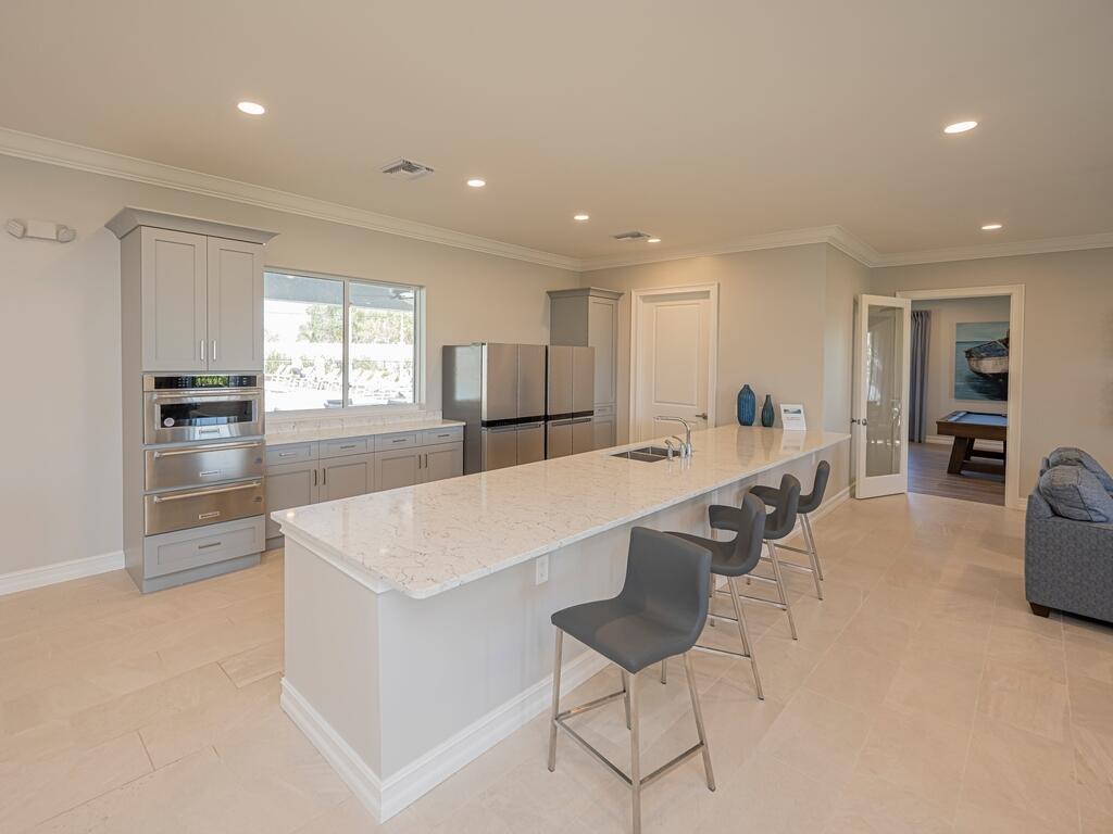 1087 Rolling Brk Lane Naples, FL 34114 - Photo 25 of 33 a large white kitchen with lots of counter space and refrigerator