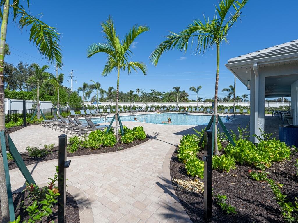 1087 Rolling Brk Lane Naples, FL 34114 - Photo 26 of 33 a view of a swimming pool with a table and chairs