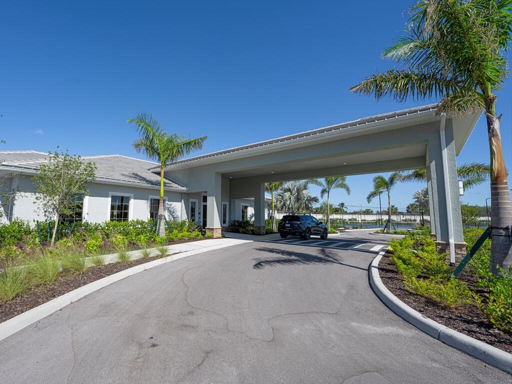 1087 Rolling Brk Lane Naples, FL 34114 - Photo 27 of 33 a view of a patio with table and chairs under an umbrella